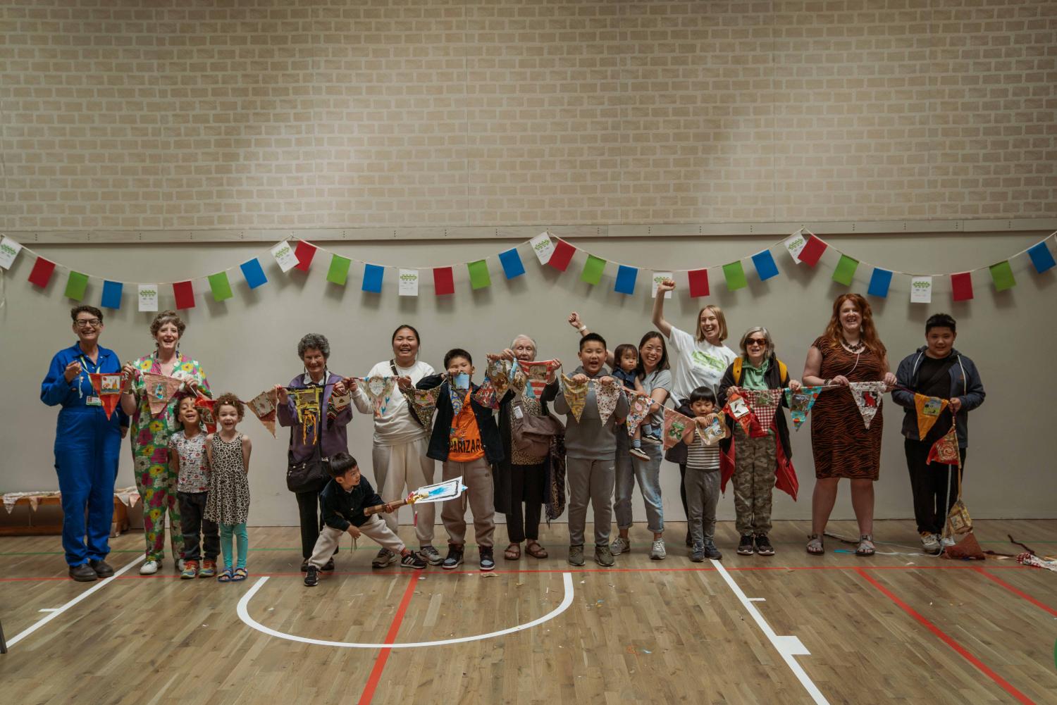 A group stand with their homemade recycled bunting in a sports hall